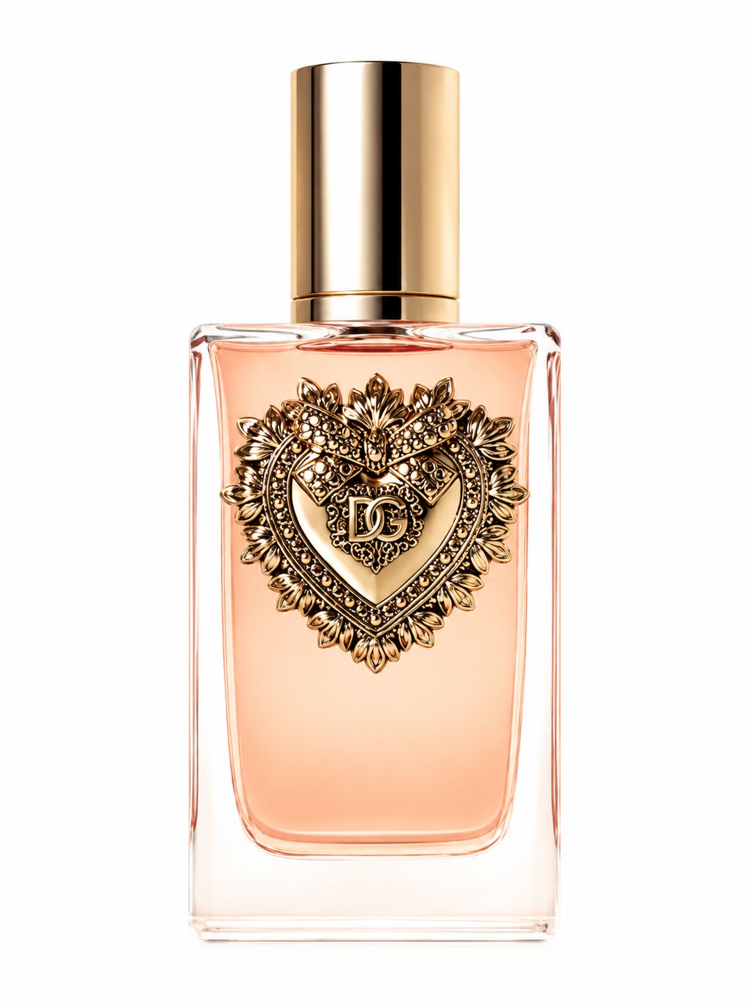 Dolce & Gabbana Devotion Eau de Parfum bottle isolated on a clean white background, featuring a transparent glass bottle filled with soft peach-colored fragrance and an elegant gold cap. The front of the bottle is adorned with the iconic handcrafted Sacred Heart emblem in gold, inspired by Italian heritage and fine jewelry, highlighting the luxurious design of this women's gourmand floral fragrance.
